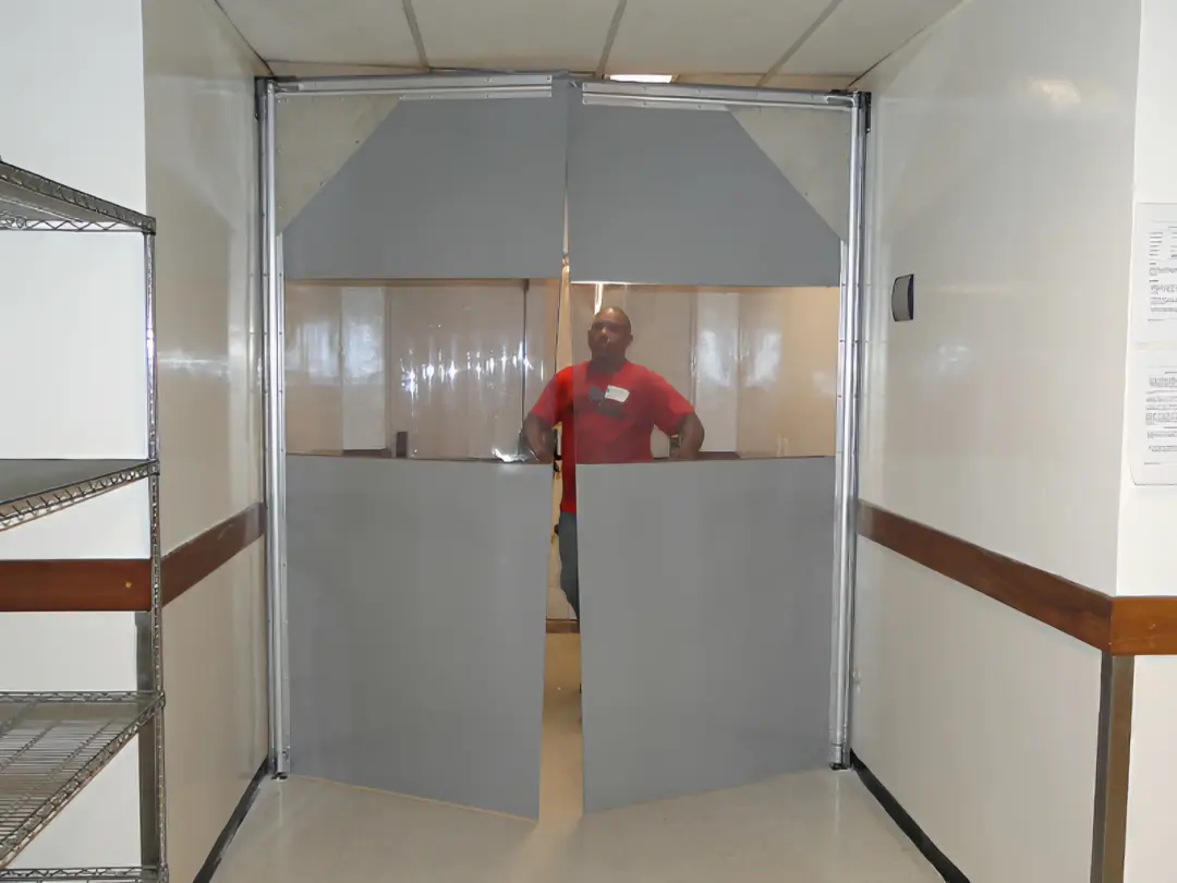 Porta vai e vem em uma passagem de pessoas- Porta fabricada pela Rebiplast - Modelo: RBFLEX